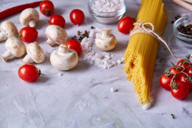 Pişmemiş makarna, domates ve baharat beyaz arka plan, üstten görünüm, yakın çekim, seçici odak