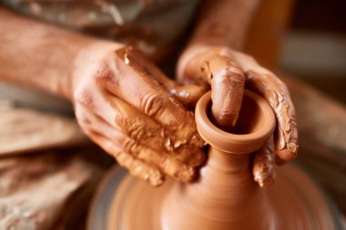 Yetişkin erkek potter usta kil plaka potters tekerlek üzerinde modelleme. Üstten Görünüm, portre, sadece eller.