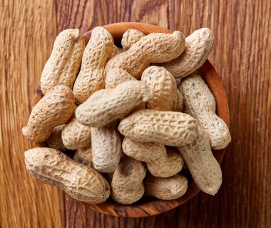 Ahşap kase rustik ahşap arka plan closeup, seçici odak içinde soyulmamış fıstık