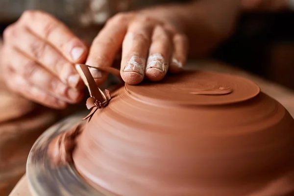 Close-up hands of a male potter in apron making a vase from clay, selective focus — Stock Photo, Image