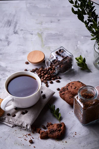 Breakfast background with mug of fresh coffee, homemade oatmeal cookies, grind coffee