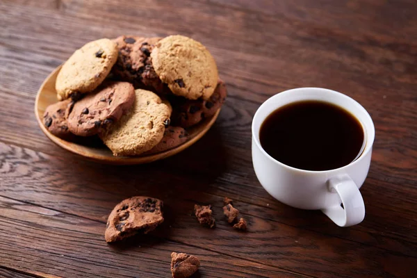 Coffee cup, jar with coffee beans, cookies over rustic background, selective focus, close-up, top view — Stock Photo, Image