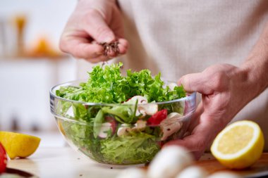 Adam seçici odak sağlıklı sebze salatası, yakın çekim, yapım mutfak yemek.