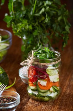 Kavanoz ve tablo, seçici odak, yakın çekim kesme tahtası üzerinde taze sebzeler lezzetli sebze salatası