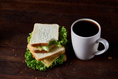 Kahvaltı Masası sandviç ve kahve rustik ahşap arka plan, yakın çekim, seçici odak ile