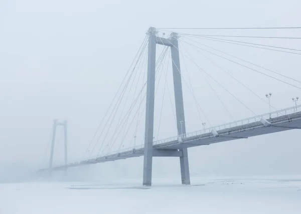Bridge over the river in a fog.