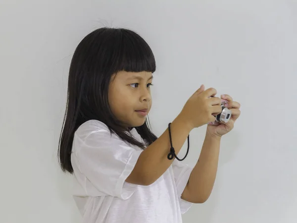 Happy little girl photographer doing photos with still camera on — Stock Photo, Image