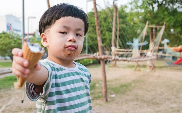 Baby handed ice cream to be morose, focus to face object, — Stock Photo, Image