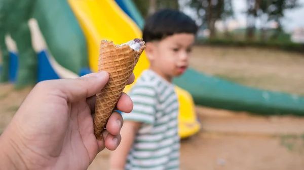 Close up of man hand holding fresh waffle cone, eat ice cream ha