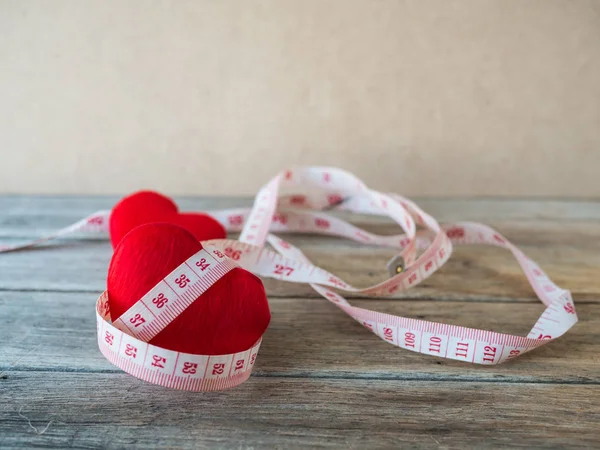 Heart with measurement tape on wood background, — Stock Photo, Image
