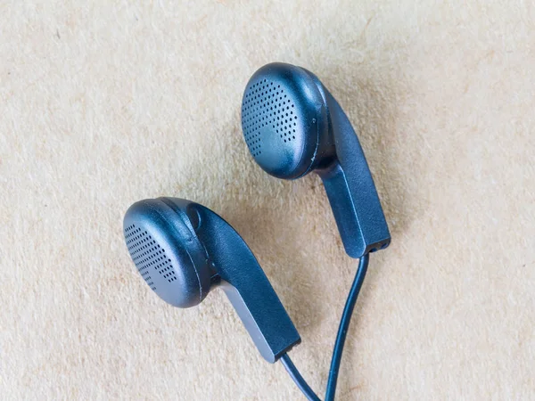 Earphones on wood background — Stock Photo, Image