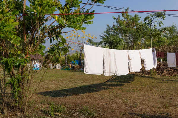 Wash clothes on a rope with clothespins, Wet clothes drying on t