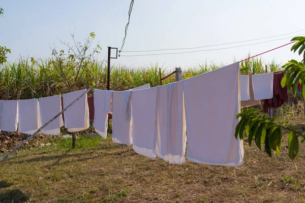 Bir ip clothespins ile üzerinde çamaşır yıkamak, t kurutma giysiler ıslak