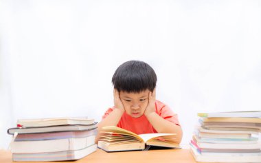 Cute a boy reading book on the table and white background, A lit
