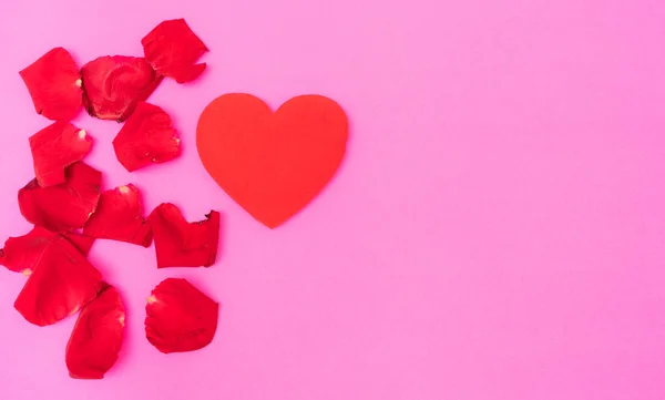 Red rose petal and red heart on pink background, — Stock Photo, Image