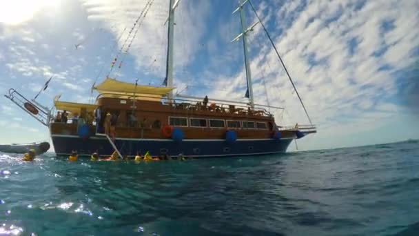 La gente baja al mar con un yate de vela — Vídeos de Stock