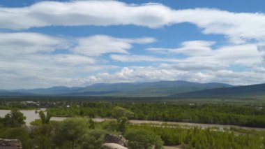 Bulutlu bir gökyüzüne karşı nehir ve dağlar. Georgia