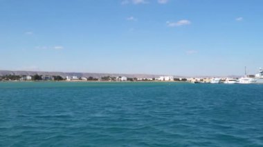 Rıhtımda turistik tekne ve gemiler var. Mısır 'da Kızıl Deniz kıyısında. El Gouna şehri. Yüzen bir tekneden görüntü