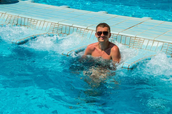 Smiling man tourist relaxing in pool jacuzzi outdoor at spa resort enjoyed luxury life. Sukses, gaya hidup sehat, konsep perawatan tubuh . — Stok Foto