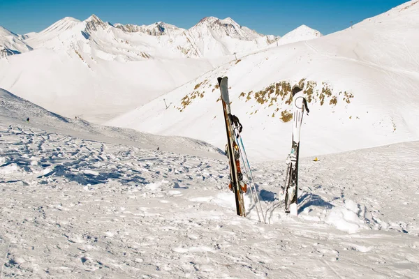 Pair skis in snow. Skiing, winter season. Mountain landscape. Extreme sport. Active lifestyle. Danger concept. Tourism industry. Negative space.