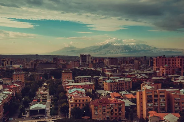 Inspirational Yerevan cityscape. Travel to Armenia. Tourism industry. Mount Ararat on background. Dramatic sky. Armenian architecture. City tour. Urban landscape. Street view. Sightseeing concept.