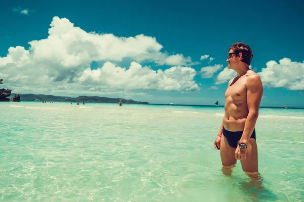 Caucasian man look into the distance enjoying summer beach vacation. Time to travel. Stress free. Shirtless fit athletic male body. Exotic luxury holiday. Tourism concept. Copy space. Wear swimsuit — Stock Photo, Image