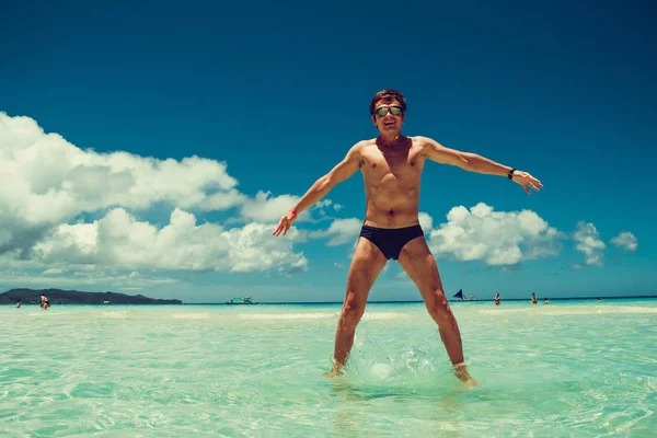 Happy excited cheerful funny man in swimming goggles enjoying summer beach vacation. Time to travel. Stress free concept. Shirtless athletic male body. Exotic luxury holiday. Copy space. Wear swimsuit — Stock Photo, Image
