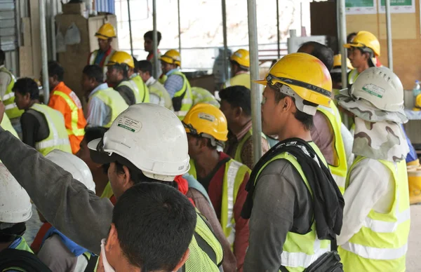 Group of construction workers assemble at the open space — Stock Photo, Image