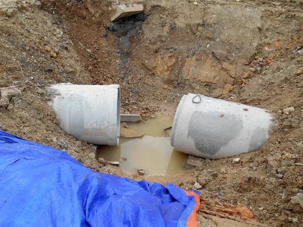 Precast concrete round culvert drain under construction at the construction site.