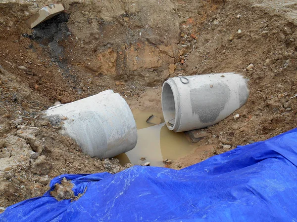 Precast concrete round culvert drain under construction at the construction site.