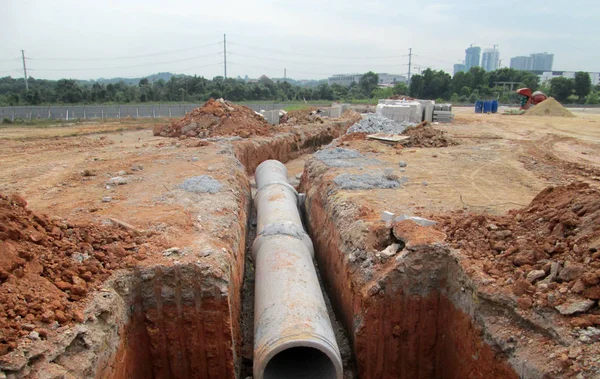 Precast concrete round culvert drain under construction at the construction site.