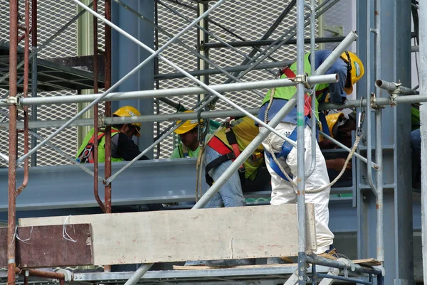 Bauarbeiter arbeiten auf der Baustelle in luftiger Höhe. — Stockfoto