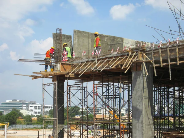 Trabalhadores da construção civil que fabricam madeira no estaleiro — Fotografia de Stock