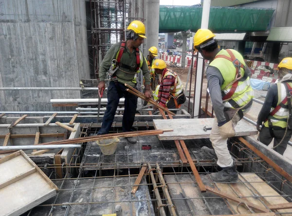 Construction workers fabricating timber form work at the construction site — Stock Photo, Image