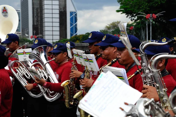 Brass band player is playing a musical instrument while guided by musical notes — Stock Photo, Image