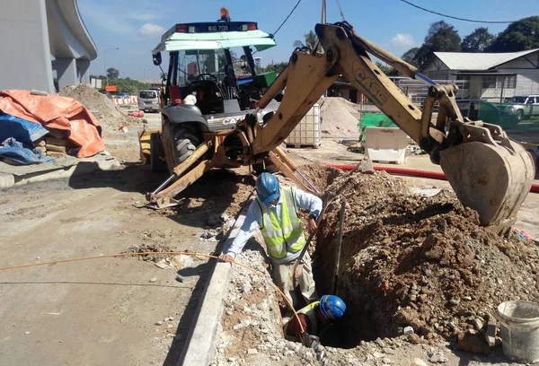  İnşaat İşçileri yeraltı boru sabitleme