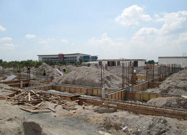 KUALA LUMPUR, SEPTEMBER 17, 2015: Building ground beam reinforcement bar and formwork fabricated at the site by construction workers. Concrete will be poured into it after satisfied by the engineer.