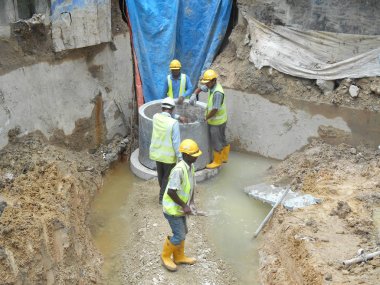 Malacca, Malaysia-31 Ocak 2017: drenaj iş inşaat işçileri tarafından. İnşaat İşçileri prekast u şeklinde beton drenaj inşaat sahasında yükleme. 