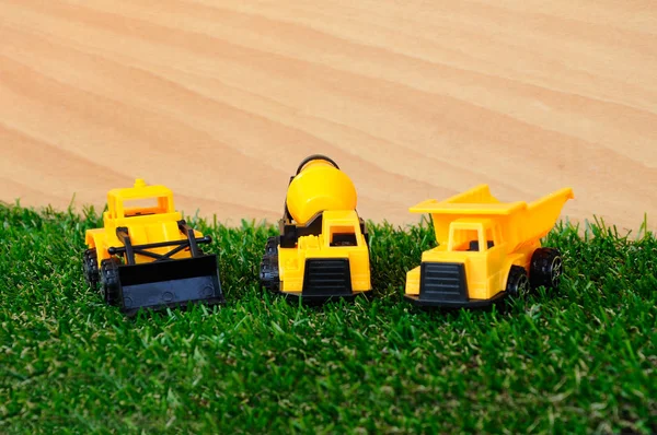 stock image Heavy construction machine toys made of plastic isolated on the artificial grass. 