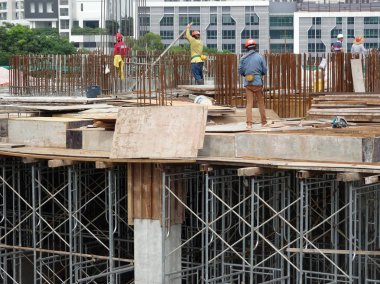 Kuala Lumpur, Malezya-07 Temmuz 2017: inşaat işçileri yükseklikte inşaat alanında çalışıyor. İskele geçici platformu olarak çalışmak için kullanma. Onlar uygun güvenlik dişli giymek için gerekli olan. 