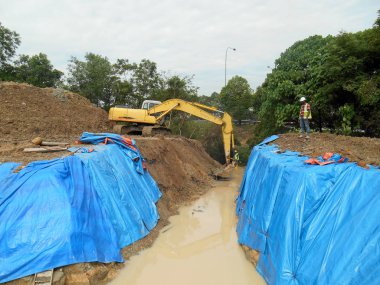Kuala Lumpur, Malezya-16 Şubat 2017: Ekskavatör inşaat sırasında toprak kazmak için kullanılan ağır inşaat makine bir makinedir. Uzun hidrolik kolu ile bir kova tarafından desteklenmektedir. 