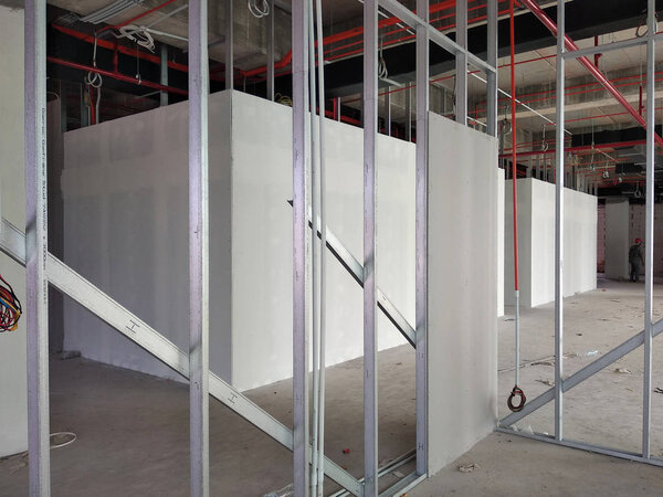 KUALA LUMPUR, MALAYSIA -APRIL 12, 2018: Drywall installation work in progress by construction workers at the construction site. It is the easiest and cheapest way to do partition for the interior wall. 