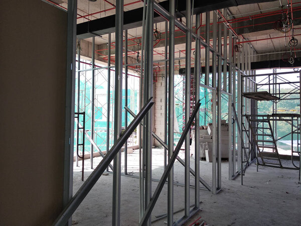 KUALA LUMPUR, MALAYSIA -APRIL 12, 2018: Drywall installation work in progress by construction workers at the construction site. It is the easiest and cheapest way to do partition for the interior wall. 