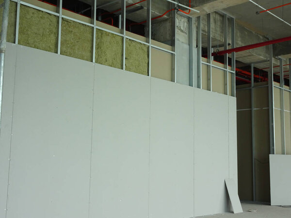 KUALA LUMPUR, MALAYSIA -APRIL 12, 2018: Drywall installation work in progress by construction workers at the construction site. It is the easiest and cheapest way to do partition for interior wall. 