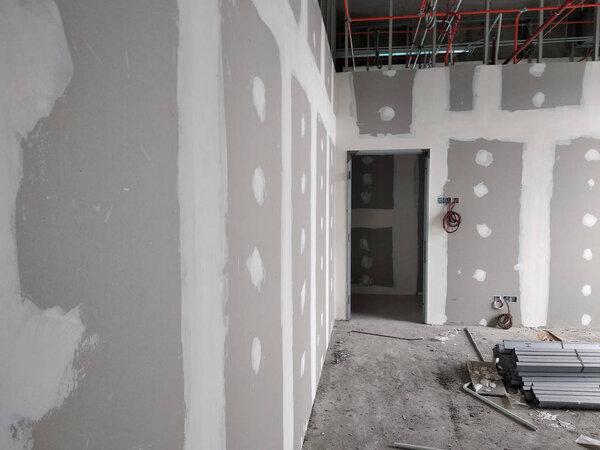 KUALA LUMPUR, MALAYSIA -APRIL 12, 2018: Drywall installation work in progress by construction workers at the construction site. It is the easiest and cheapest way to do partition for interior wall. 