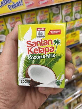 Kuala Lumpur, Malezya -14 Aralık 2019: İşlenmiş hindistan cevizi sütü kağıt kutuda paketlenmiş ve süpermarketin içindeki çelik bir rafta sergilenmektedir. Markaya göre sıralanır. 