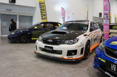 KUALA LUMPUR, MALAYSIA -MARCH 15, 2019: Selective focused of car showroom inside the huge hall. Displayed for sale to the visitor. Salesman ready to give good service to the customer. 