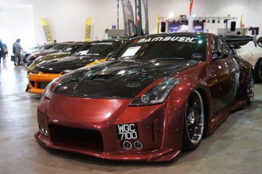 KUALA LUMPUR, MALAYSIA -MARCH 15, 2019: Selective focused of car showroom inside the huge hall. Displayed for sale to the visitor. Salesman ready to give good service to the customer. 