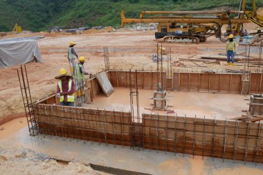 KUALA LUMPUR, MALAYSIA -MARCH, 2019: Construction workers installing & fabricating ground beam timber form works at the construction site. The formworks made from timber and plywood. 