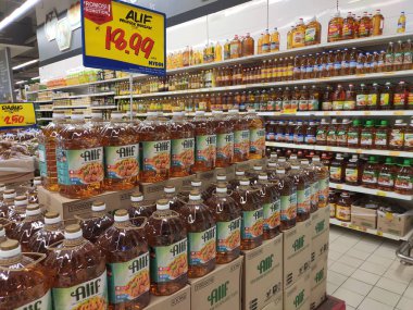 Kuala Lumpur, Malezya - 29 Eylül 2019: Süpermarkette satılmak üzere işlenmiş palmiye yağından yapılan pişirme yağı. Müşterinin seçmesini kolaylaştırmak için markaya göre sıralanır. 